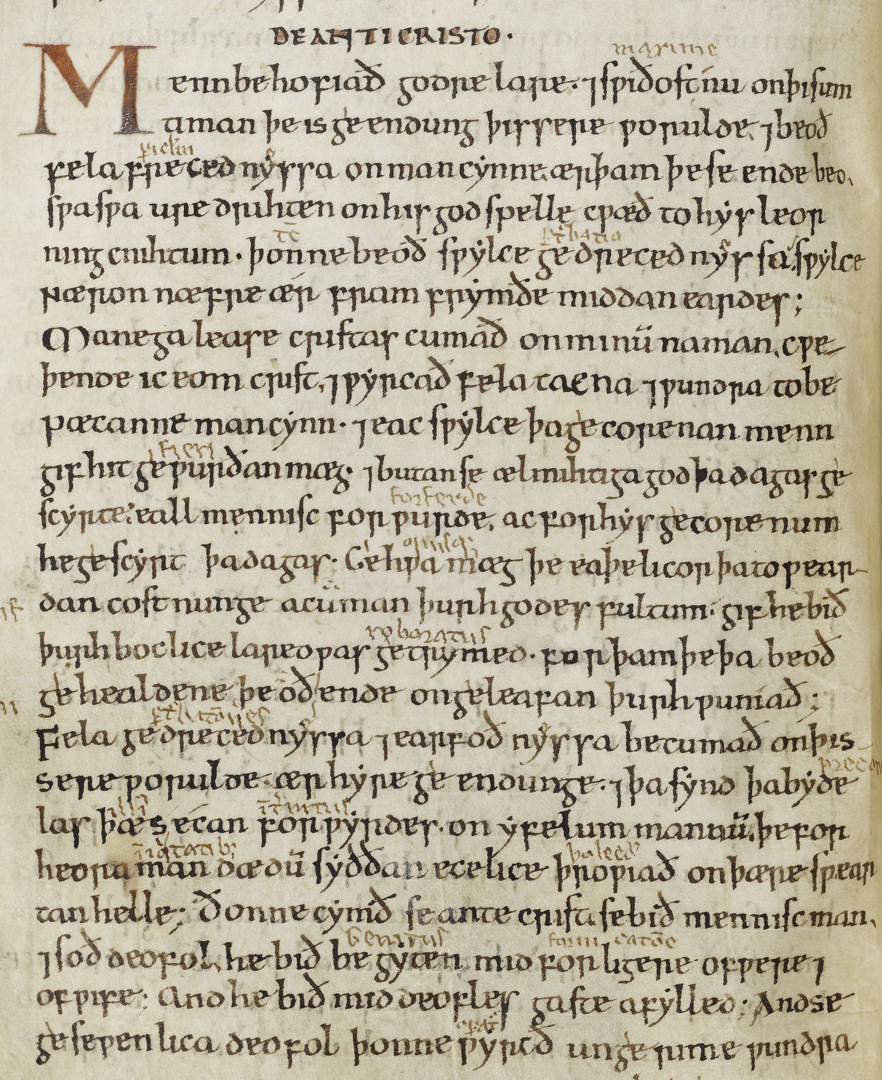 This manuscript page displays the beginning words of Ælfric's Preface in Old English. The capital M of the first word is considerably larger than the other letters. A second, shakier scribal hand has written interlinear words throughout.