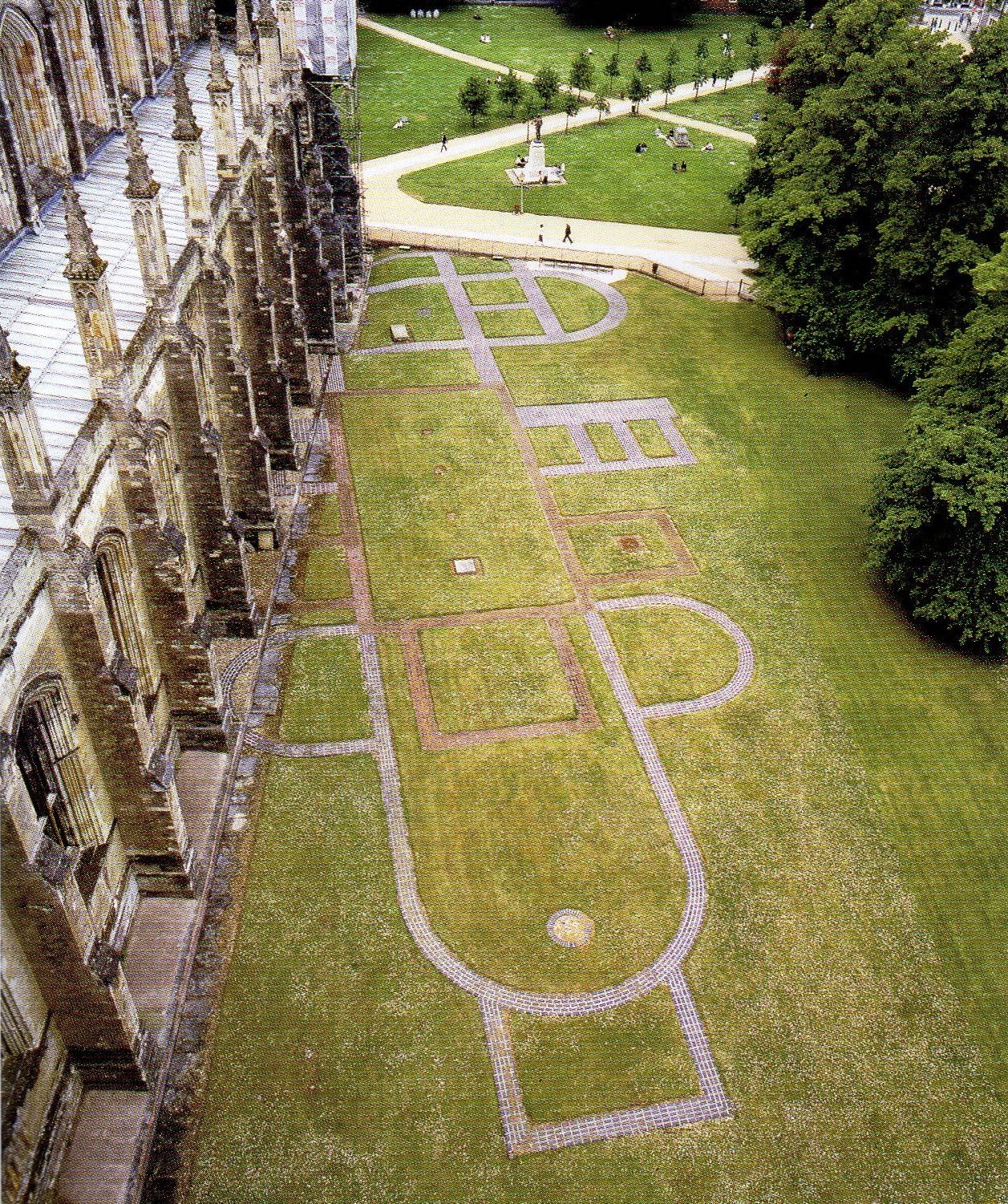 Jutting out from the side of the Winchester Cathedral is the tile outline of the Old Minster of Winchester. The two structures share an apse, but the Old Minster tile outline shows where the original rooms would have been located. The outline is vaguely cruciform, and the altar lies on the side closest to the viewer.